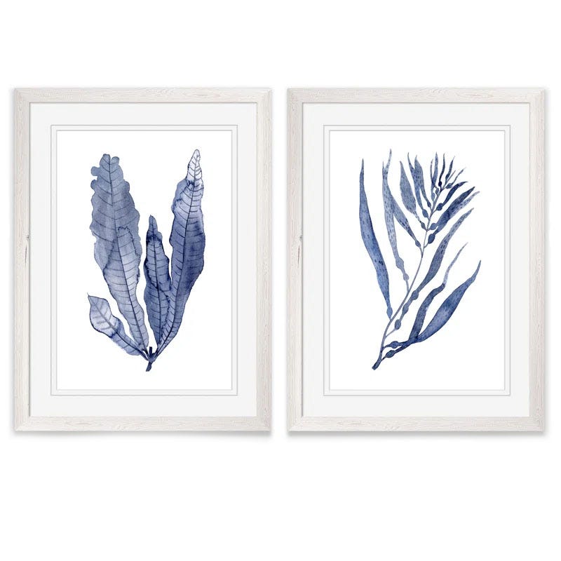 Two framed artworks feature blue-toned botanical illustrations, each depicting different leaf designs in a minimalist style.