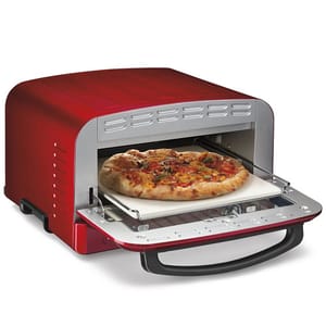 A red countertop pizza oven with a pizza inside, partially visible through the open door.