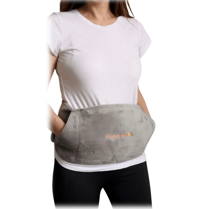 A person is wearing a grey waist warmer with the stitched text \“Happy Heat\“ on the front; it's designed to provide warmth around the midsection.