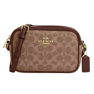 Coach camera bag in brown with signature canvas pattern, featuring gold-tone hardware, adjustable strap, and attached tag.