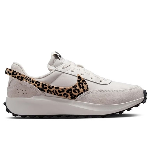 White sneaker with suede accents and a leopard print swoosh, featuring a thick sole and structured design.