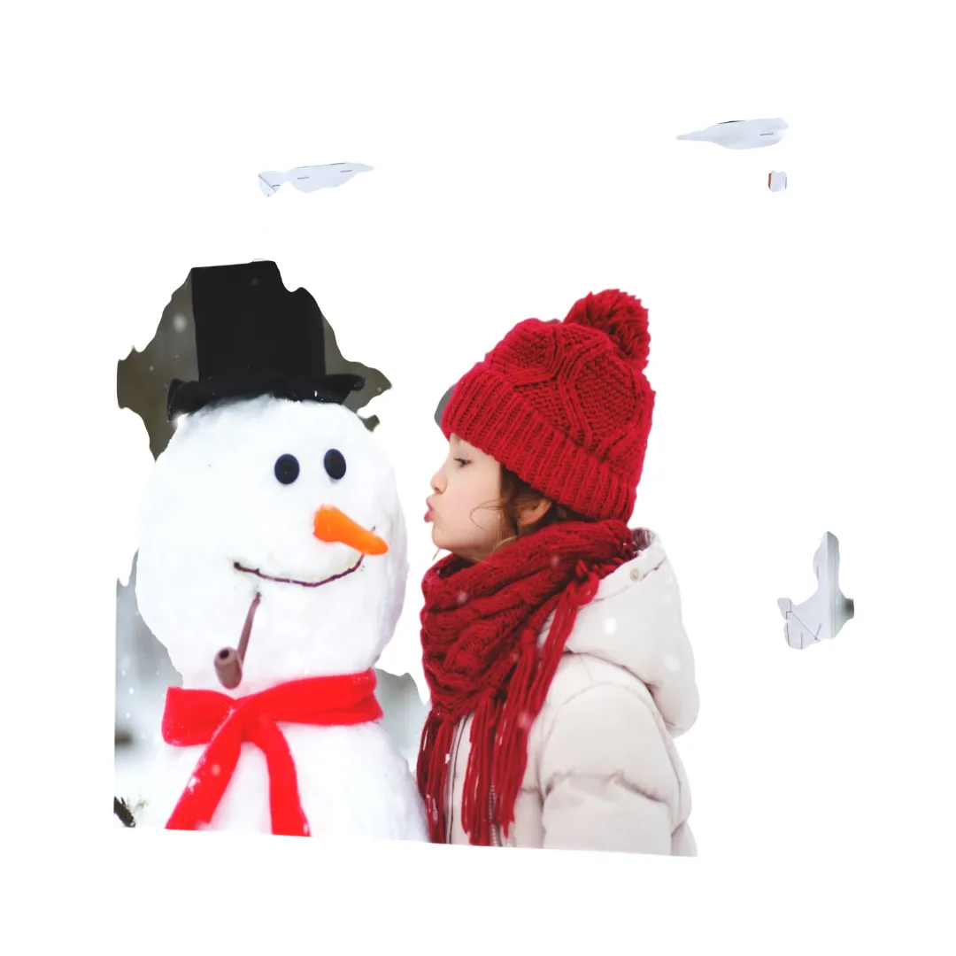 A canvas print features a child in a red hat and scarf interacting with a snowman wearing a black top hat and red scarf, set in a snowy backdrop.