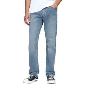 A person is wearing light blue jeans paired with black and white sneakers and a white shirt.