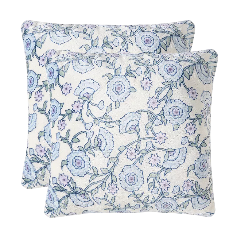 Two decorative pillows with a floral pattern in shades of blue and lavender on a white background.