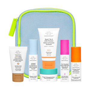 Skincare set featuring Drunk Elephant's Beste No. 9 Jelly Cleanser, B-Hydra Intensive Hydration Serum, T.L.C. Framboos Glycolic Night Serum, C-Firma Fresh Day Serum, Protini Polypeptide Cream, and Umbra Tinte Mineral Cream, all in travel sizes.