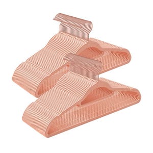 50pk of blush-colored velvet hangers with a slim, non-slip design, featuring metal hooks for hanging clothes.