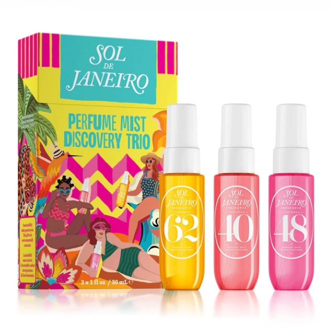 Three Sol de Janeiro perfume mist bottles in yellow, pink, and red are displayed in front of their vibrant, tropical-themed packaging.