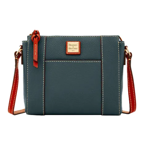 A teal leather crossbody bag with a red and tan adjustable strap and a small logo patch in the center.