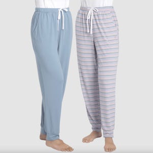 Two pairs of pajama pants, one solid light blue and one with multicolor stripes.