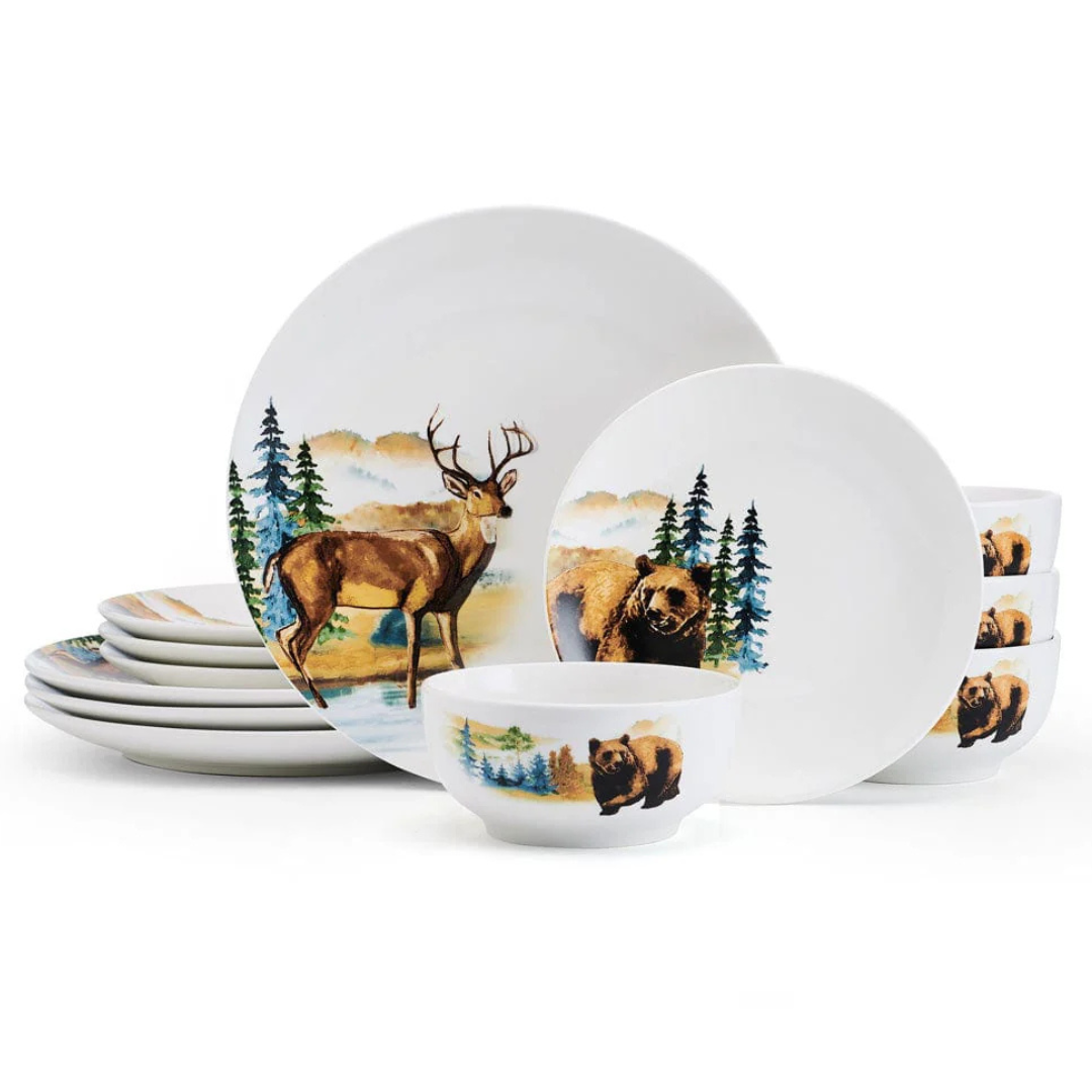 A dinnerware set featuring wildlife designs, including a deer and a bear, with a forest landscape in the background. The set includes plates and bowls.