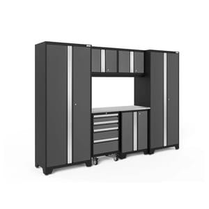 7-piece garage storage system featuring two tall cabinets, three overhead cabinets, a rolling tool cabinet with drawers, and a work surface, all in a black and silver color scheme.