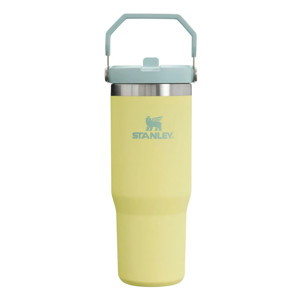 A yellow Stanley travel mug with a blue lid and handle, featuring the Stanley logo.