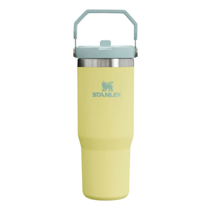 A yellow Stanley travel mug with a blue lid and handle, featuring the Stanley logo.