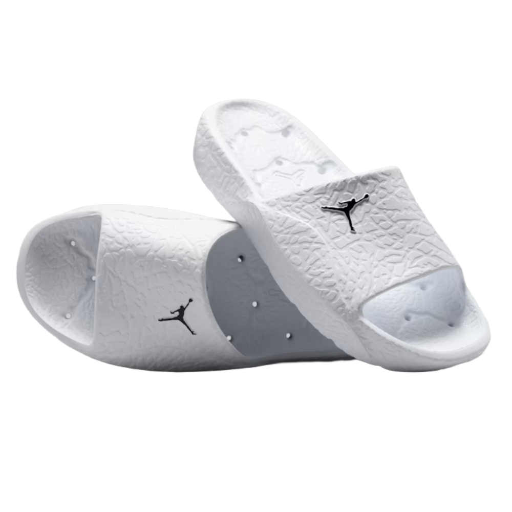 A pair of white slide sandals featuring a black logo, textured with a design reminiscent of elephant print.