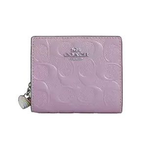 Pink Coach wallet with embossed signature pattern and silver logo, featuring a zipper pull with a decorative charm.