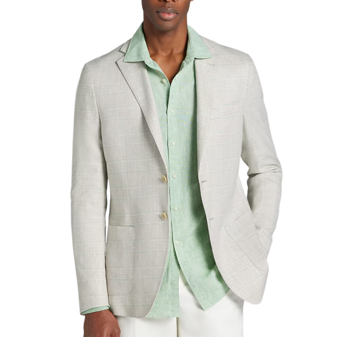 A man is wearing a light beige plaid blazer over a mint green collared shirt, paired with white pants, with one hand in his pocket.