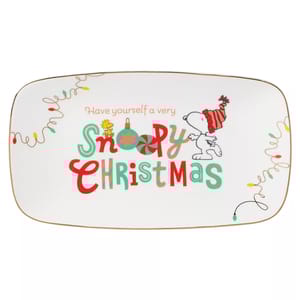 Rectangular plate with a holiday theme featuring Snoopy and Woodstock, decorated with colorful lights and the phrase “Have yourself a very Snoopy Christmas.”
