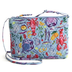 A quilted crossbody bag with an all-over seafood and kitchen theme, featuring colorful lobsters, crabs, fish, lemons, and kitchen items on a light blue background. It includes an adjustable strap and a zippered closure.