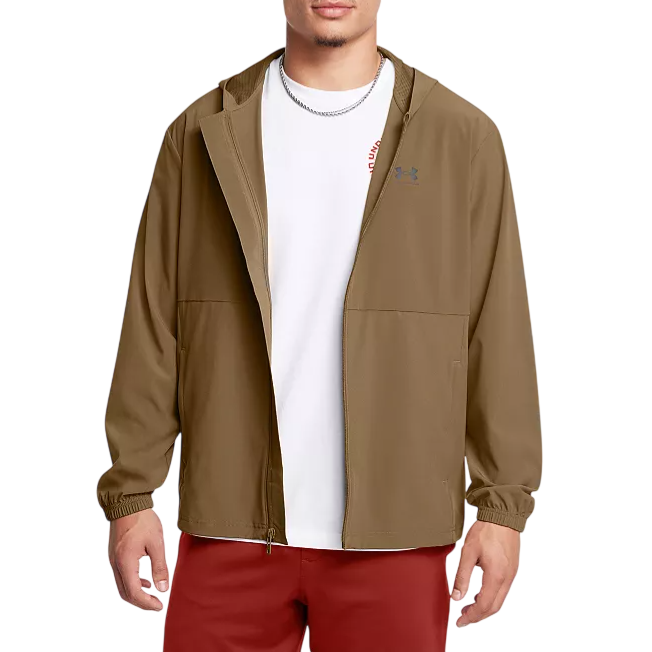 A person is wearing a brown Under Armour hooded jacket over a white t-shirt, paired with red pants.