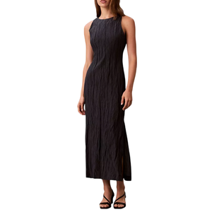 Sleeveless black crinkled midi dress with a round neckline and side slit, paired with black strappy sandals.
