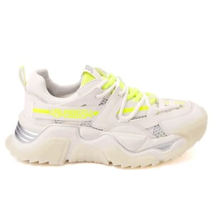 Steve Madden sneakers with a chunky sole, predominantly white with neon yellow accents, and intricate overlay designs.