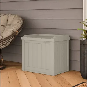 A gray deck storage box on a porch next to a hanging chair and a potted plant.