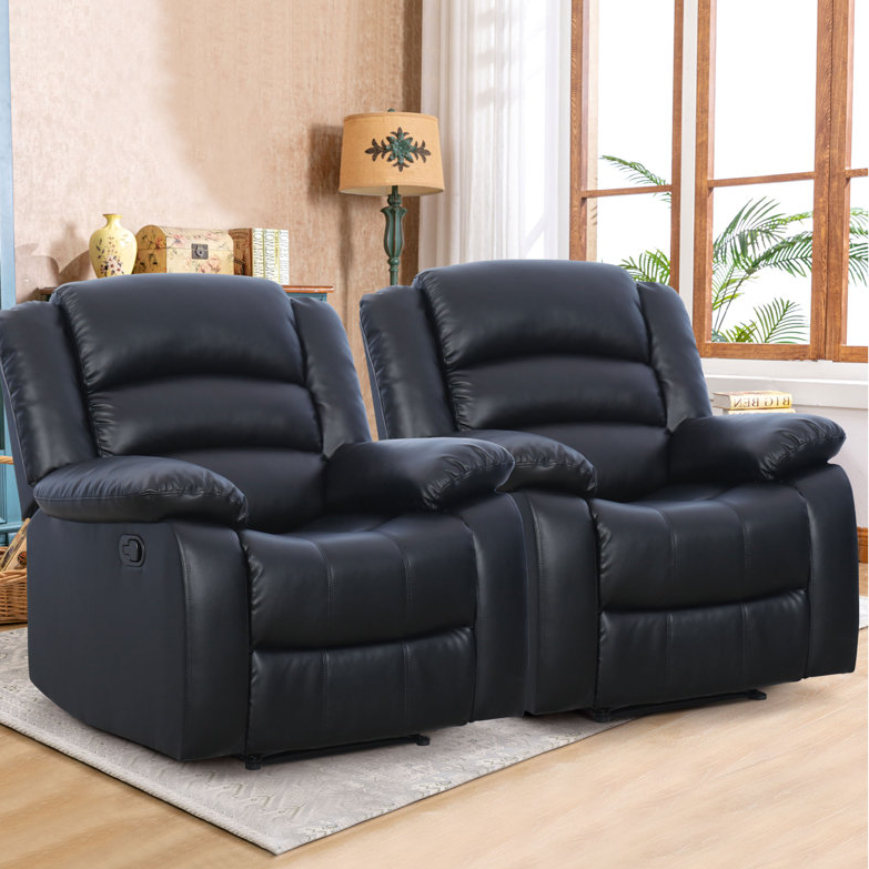 A pair of black leather recliner chairs in a living room setting.