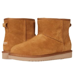Koolaburra by UGG Mini Suede Boots feature a tan suede upper with a short, ankle-high design. They have a plush interior lining and a sturdy, textured sole for added grip.