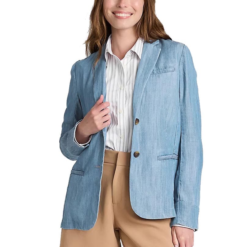 A person wears a light blue blazer over a white striped shirt, paired with tan pants.
