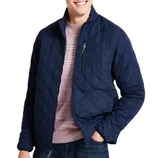 The Hawke & Co. Diamond Quilted Jacket features a navy diamond pattern, zippered chest pocket, and a fitted design. It's layered over a light pink sweater and paired with jeans.