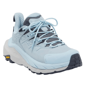 Light blue Hoka Women's Kaha Trail Shoes with a cushioned sole, lace-up design, and Vibram outsole for traction.