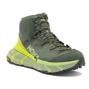 Hiking boot with a dark green upper, neon green sole, and HOKA branding, designed for outdoor use.