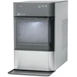 A GE Profile countertop ice maker with a transparent front, displaying a compartment full of nugget ice. It features controls for cleaning, lighting, and power on the top panel.