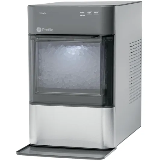A GE Profile countertop ice maker with a transparent front, displaying a compartment full of nugget ice. It features controls for cleaning, lighting, and power on the top panel.