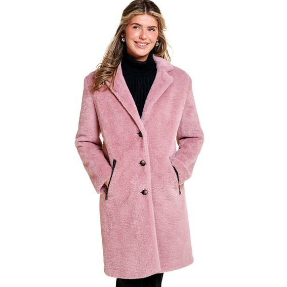 A woman is wearing a pink coat with a black turtleneck sweater.