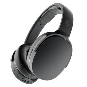Wireless over-ear headphones in black featuring a smooth design with cushioned ear pads, adjustable headband, and a USB-C charging port, adorned with a skull logo on the side.
