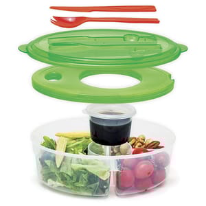 A round, multi-compartment salad container with a green lid, red fork and spoon set, and a separate small container for dressing.