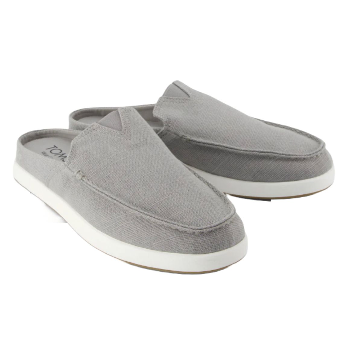 Men's TOMS Mules in light gray feature a slip-on design with a canvas upper, round toe, and white rubber sole.