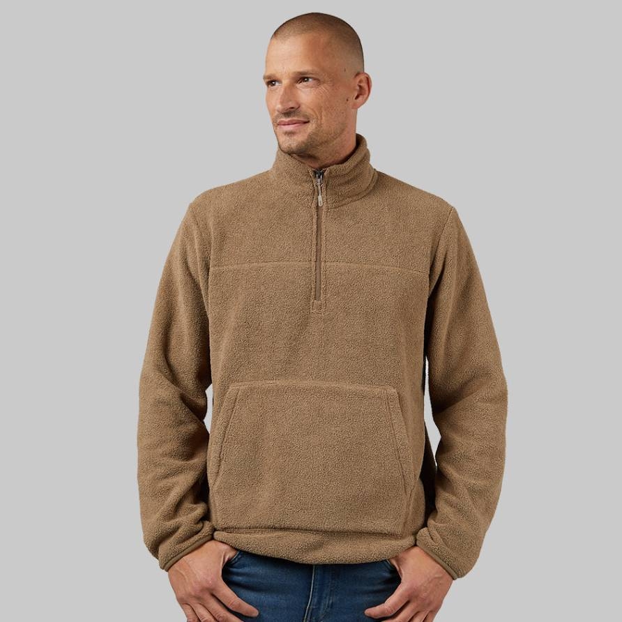 A man models a tan-colored, half-zip fleece top with a stand-up collar and a front kangaroo pocket.