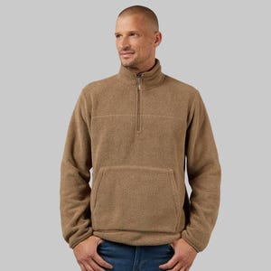 A man models a tan-colored, half-zip fleece top with a stand-up collar and a front kangaroo pocket.