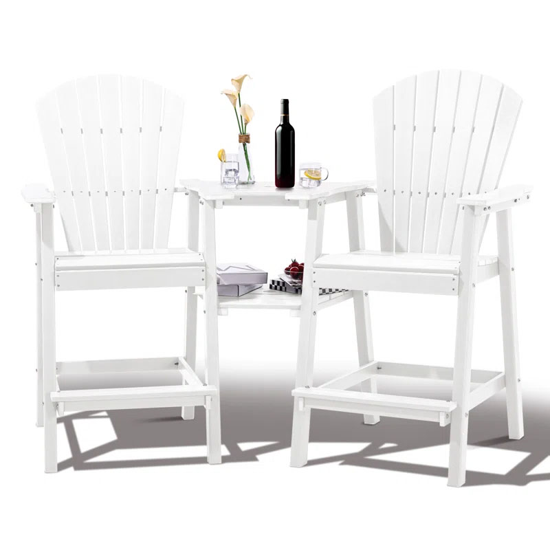 A white, tall Adirondack-style chair set with a built-in table, featuring a wine bottle, glass, vase with flowers, and a tray with cherries, suitable for outdoor use.