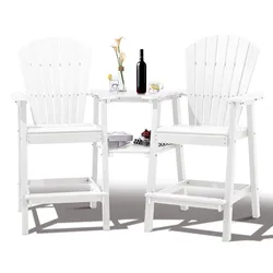 A white, tall Adirondack-style chair set with a built-in table, featuring a wine bottle, glass, vase with flowers, and a tray with cherries, suitable for outdoor use.
