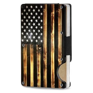 A money clip featuring a vertically oriented American flag design, with stars on the left and stripes extending downwards. The clip is bordered with metal rivets for a rugged look and holds several cards on the right side.