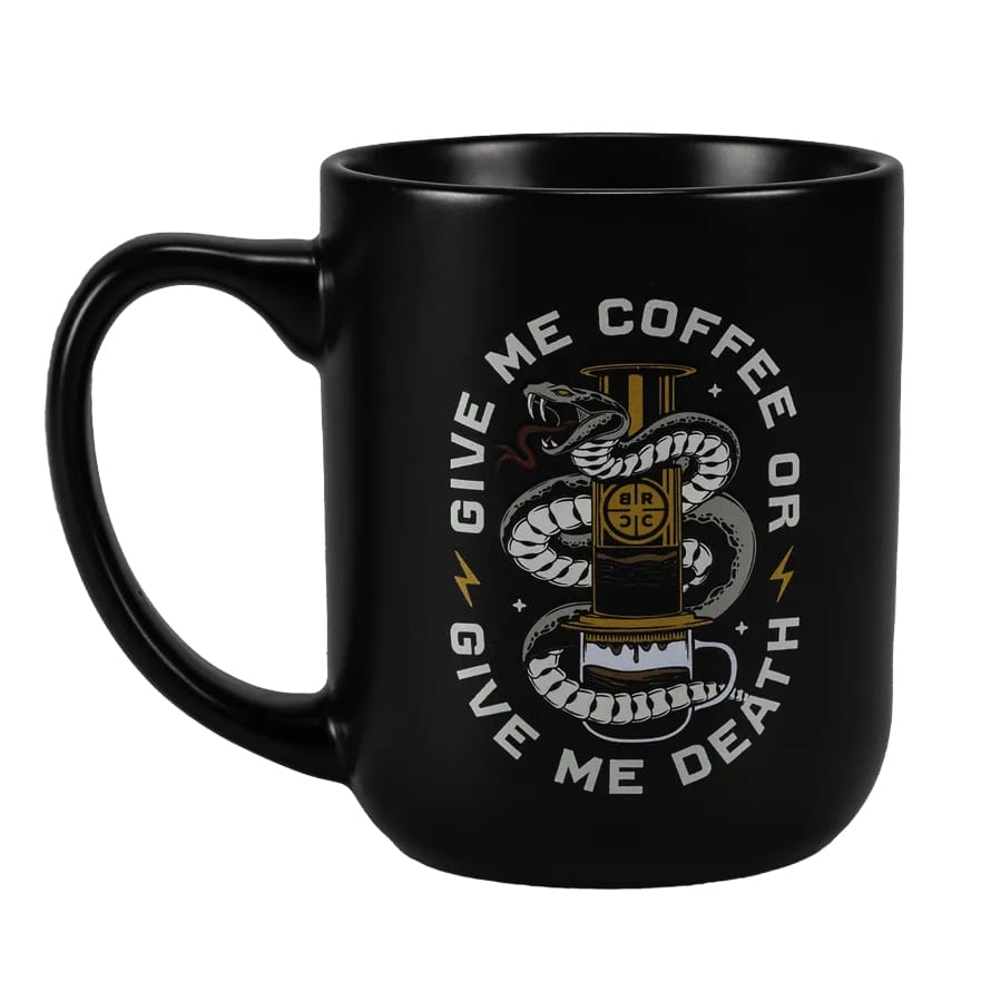 Black ceramic mug featuring a design with a snake wrapped around a coffee brewer and the text \“Give Me Coffee or Give Me Death\“ in white.