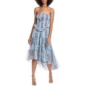 Strapless blue dress featuring floral patterns and a tiered, asymmetrical hem, paired with strappy heels.