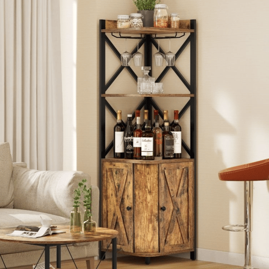 Corner bar cabinet with rustic wood shelves and black metal frame, featuring wine bottles, hanging glasses, plants, and jars. Placed beside a beige sofa and round wooden coffee table.
