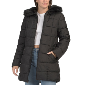 A black, quilted puffer coat with a faux fur-lined hood, worn over a white crop top and blue jeans.