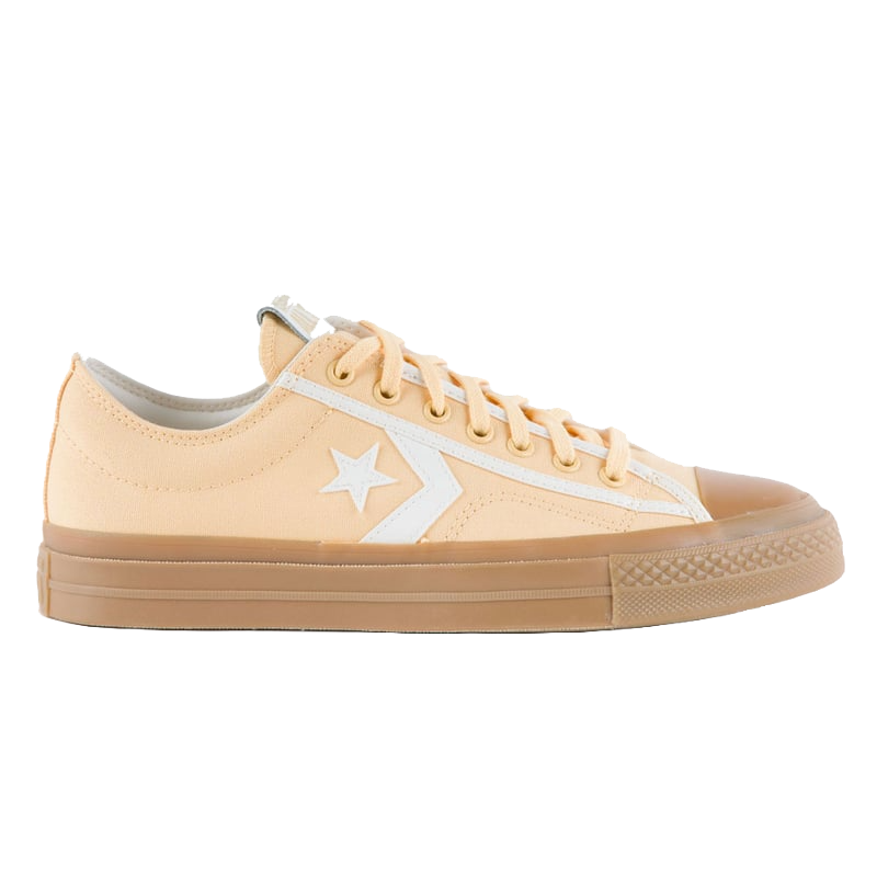Peach-colored low-top Converse sneakers with a white star and chevron design, matching laces, and a brown rubber sole.
