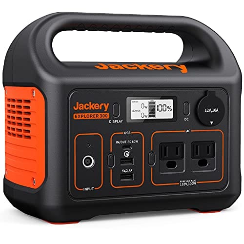 This is a portable Jackery Explorer 300 power station featuring an LCD display, multiple output ports including USB and AC, and an orange and black design with a carry handle.