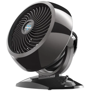 A black Vornado fan with a round, tiltable design and control dial on the base for adjusting speed settings.